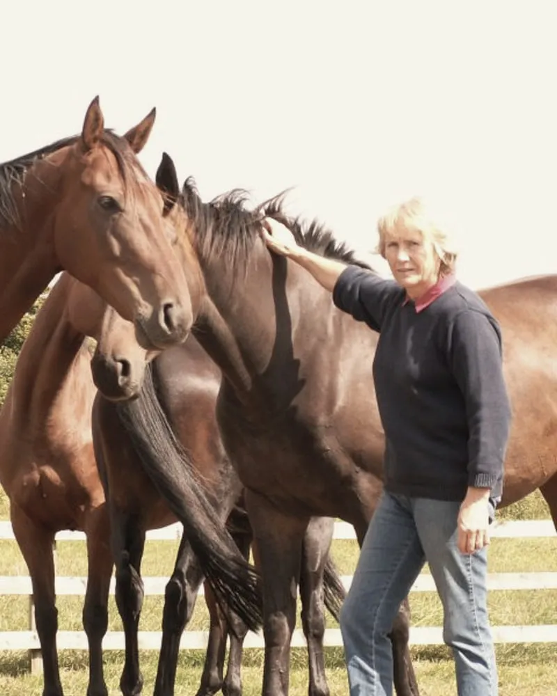 Ellen Collinson standing with her horses